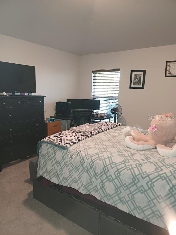 bedroom featuring light carpet