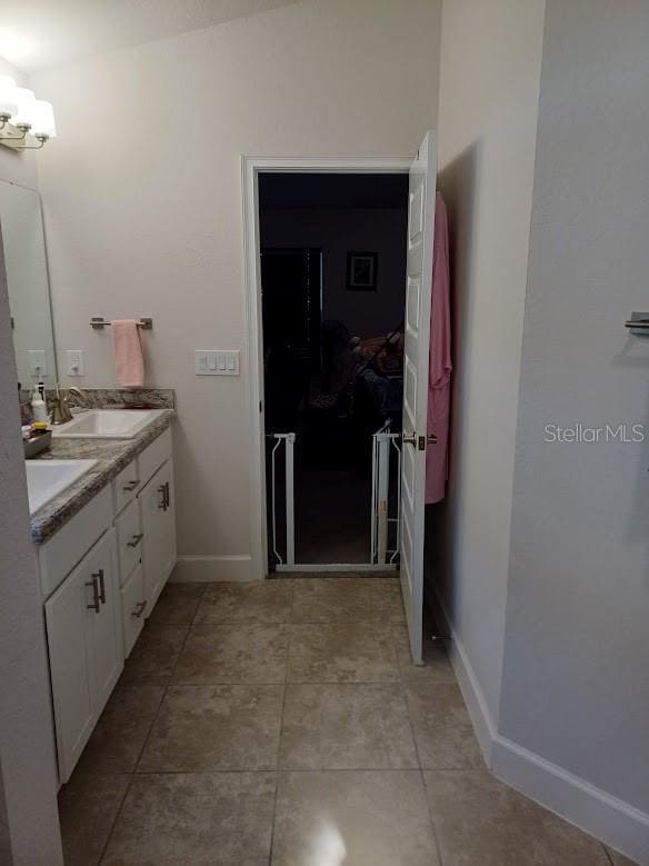 bathroom with double sink vanity and tile floors