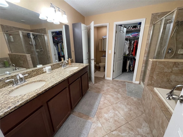 full bathroom with a textured ceiling, tile flooring, independent shower and bath, and double vanity