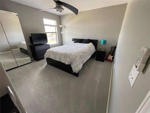 bedroom with a closet, ceiling fan, and carpet