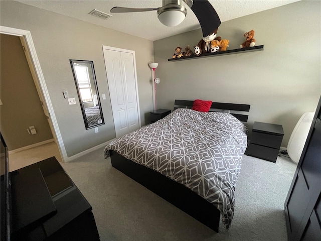 carpeted bedroom with a closet and ceiling fan