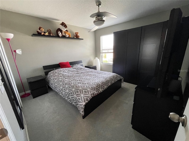 bedroom with carpet, ceiling fan, and a textured ceiling