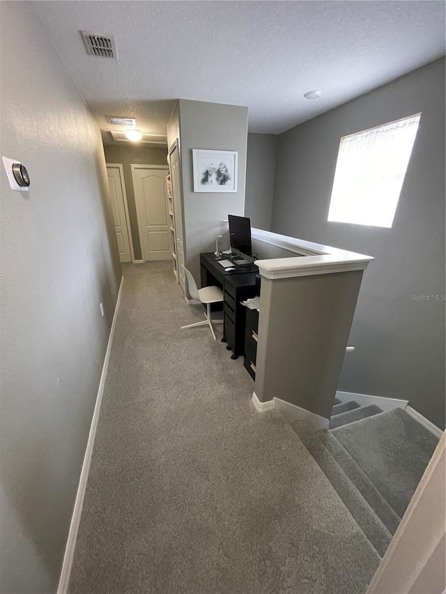 office space with a textured ceiling and carpet