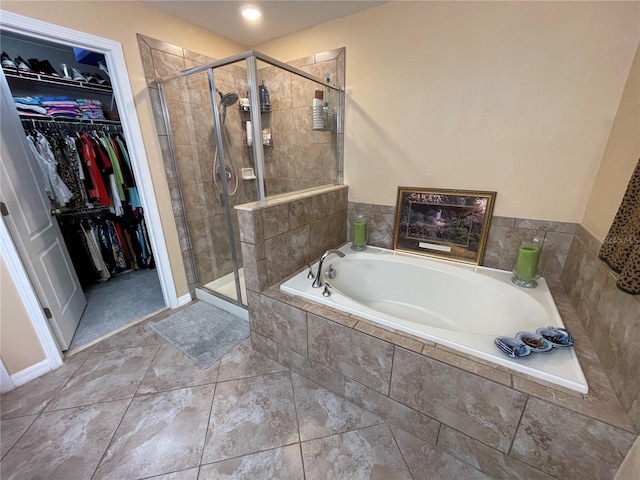 bathroom featuring separate shower and tub and tile flooring