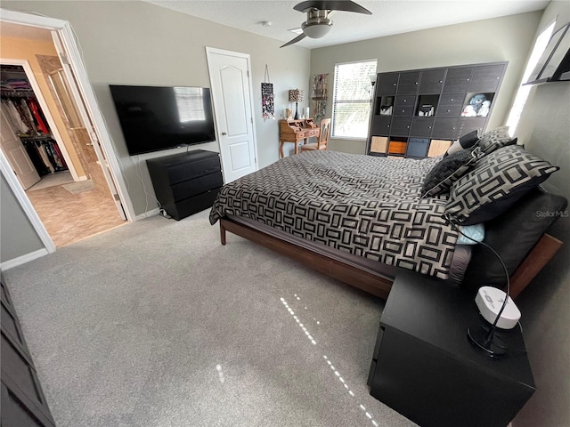 bedroom with a closet, ceiling fan, and light tile floors