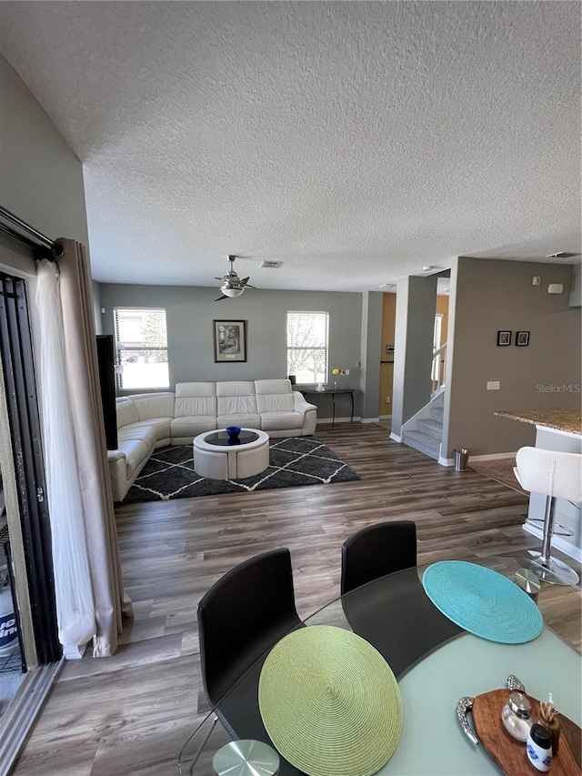 living room with hardwood / wood-style floors, a textured ceiling, and a wealth of natural light