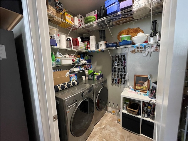 washroom featuring light tile flooring and separate washer and dryer