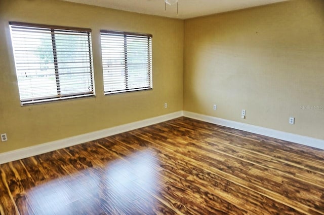 empty room with dark hardwood / wood-style floors