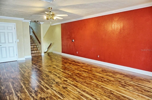 unfurnished living room featuring ceiling fan, ornamental molding, a textured ceiling, and hardwood / wood-style floors