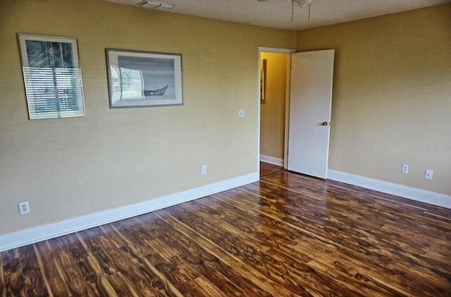 spare room featuring dark wood-type flooring