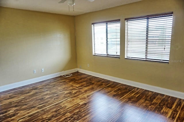 empty room featuring ceiling fan and dark hardwood / wood-style flooring