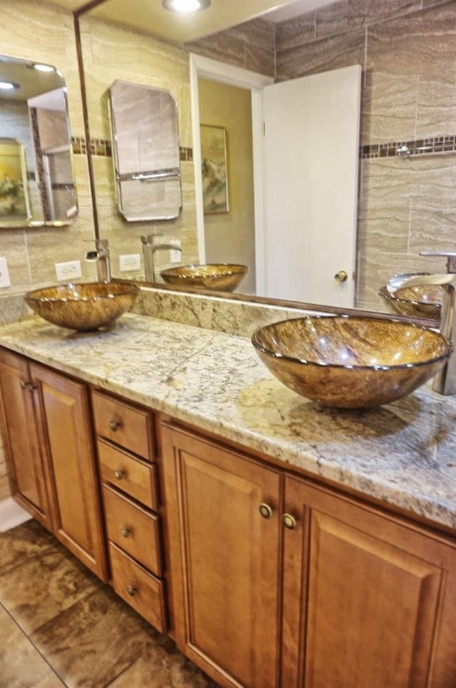 bathroom with vanity, tile walls, and backsplash