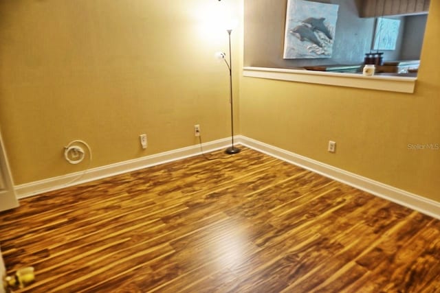 empty room with hardwood / wood-style flooring