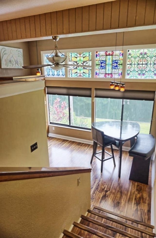 interior space with a notable chandelier, plenty of natural light, and hardwood / wood-style floors