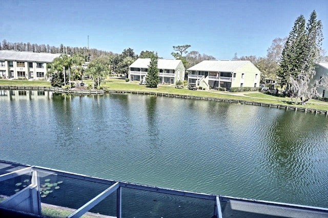 dock area featuring a water view and a yard