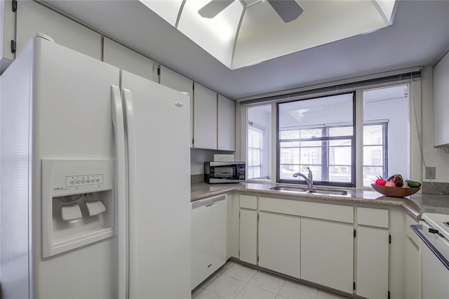 kitchen with light tile flooring, white cabinets, ceiling fan, and white appliances