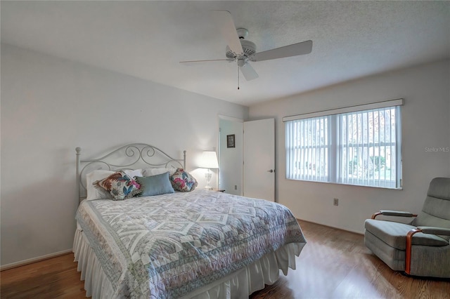 bedroom with hardwood / wood-style floors and ceiling fan