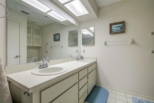 bathroom with large vanity, tile flooring, and double sink