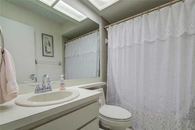 bathroom with large vanity and toilet