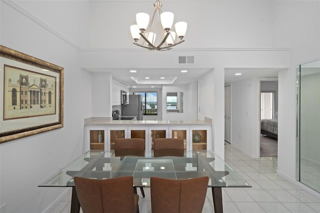 tiled dining area featuring a wealth of natural light and an inviting chandelier