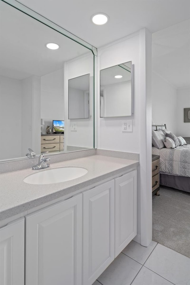 bathroom featuring vanity with extensive cabinet space and tile flooring