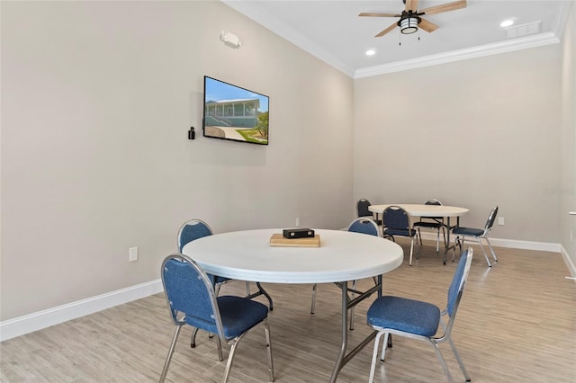 dining space featuring crown molding, ceiling fan, and light hardwood / wood-style flooring