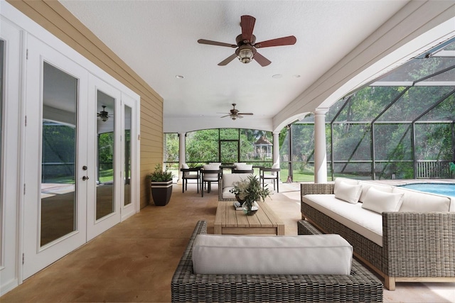 sunroom / solarium featuring french doors and ceiling fan