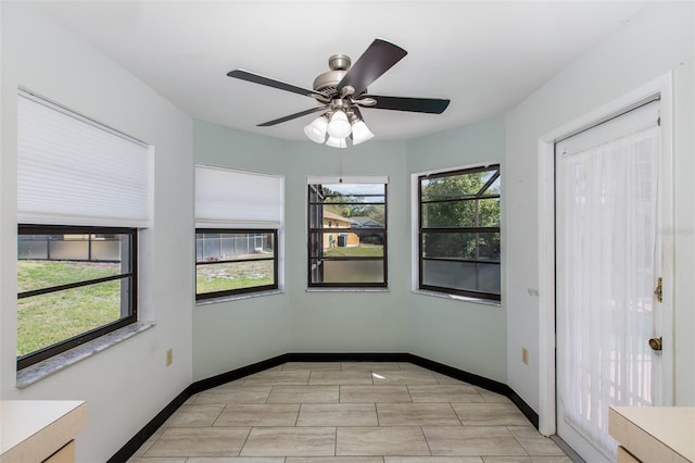 unfurnished room featuring light tile flooring and ceiling fan