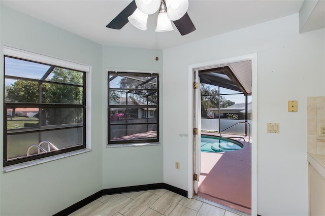 interior space with ceiling fan