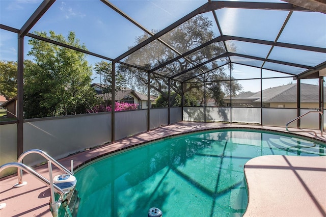 view of swimming pool featuring glass enclosure