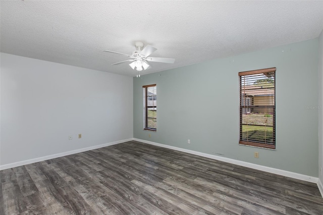 empty room with ceiling fan, a textured ceiling, and dark hardwood / wood-style flooring