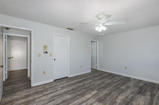 unfurnished bedroom featuring dark hardwood / wood-style floors, a textured ceiling, and ceiling fan