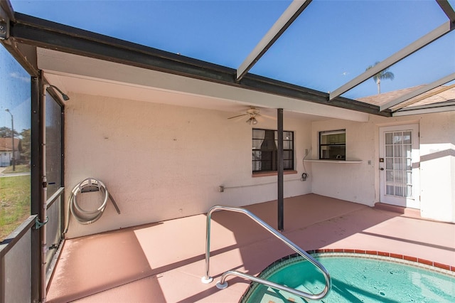 view of pool featuring a patio area, ceiling fan, and glass enclosure