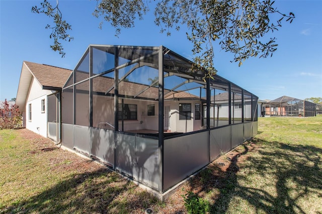 exterior space with a lanai and a yard