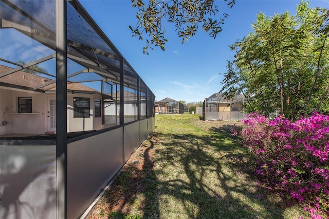 view of yard featuring glass enclosure