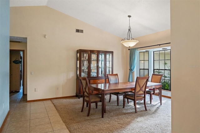 tiled dining area with high vaulted ceiling