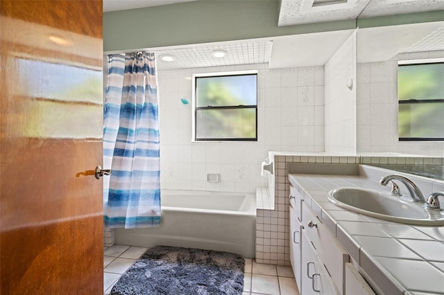 bathroom featuring tile patterned flooring, vanity, shower / bath combo with shower curtain, and tile walls