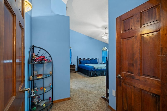 hallway featuring carpet floors and lofted ceiling