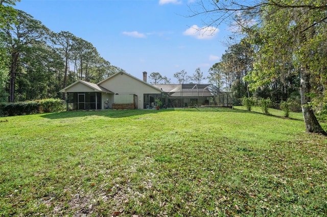 view of yard with a lanai and a sunroom