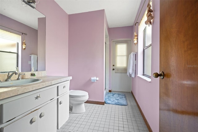 bathroom featuring tile patterned floors, vanity, and toilet