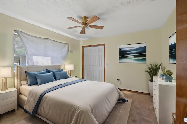 carpeted bedroom featuring a closet and ceiling fan