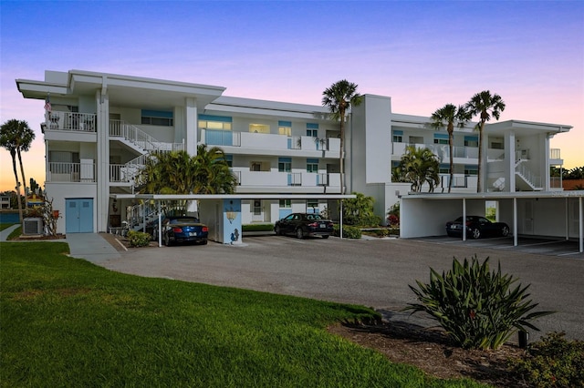 view of building exterior featuring covered parking and cooling unit