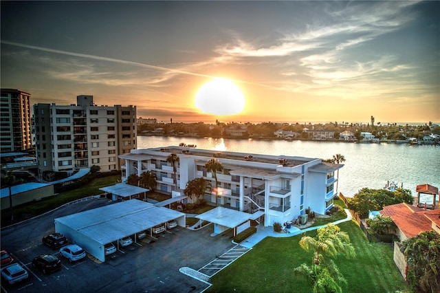 aerial view at dusk featuring a water view