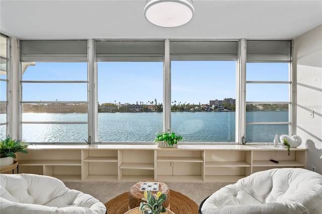 sunroom / solarium with a water view