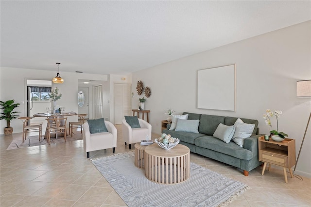 living area featuring light tile patterned flooring and baseboards