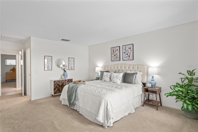 bedroom with baseboards, light colored carpet, visible vents, and attic access