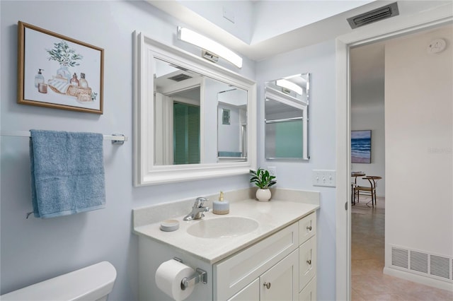 bathroom featuring toilet, tile patterned flooring, vanity, and visible vents