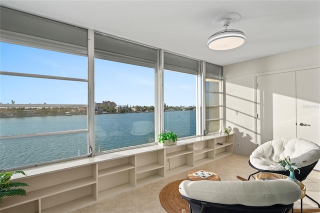 unfurnished sunroom featuring a water view