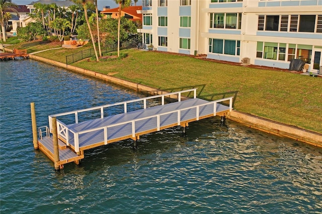 dock area featuring a water view and a yard