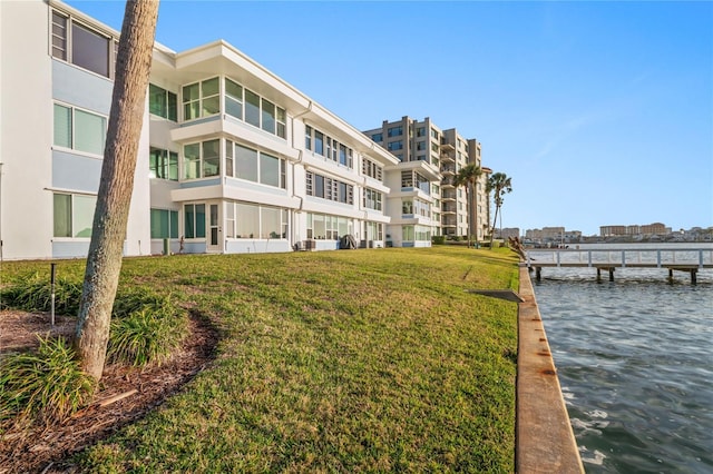 view of dock featuring a yard and a water view